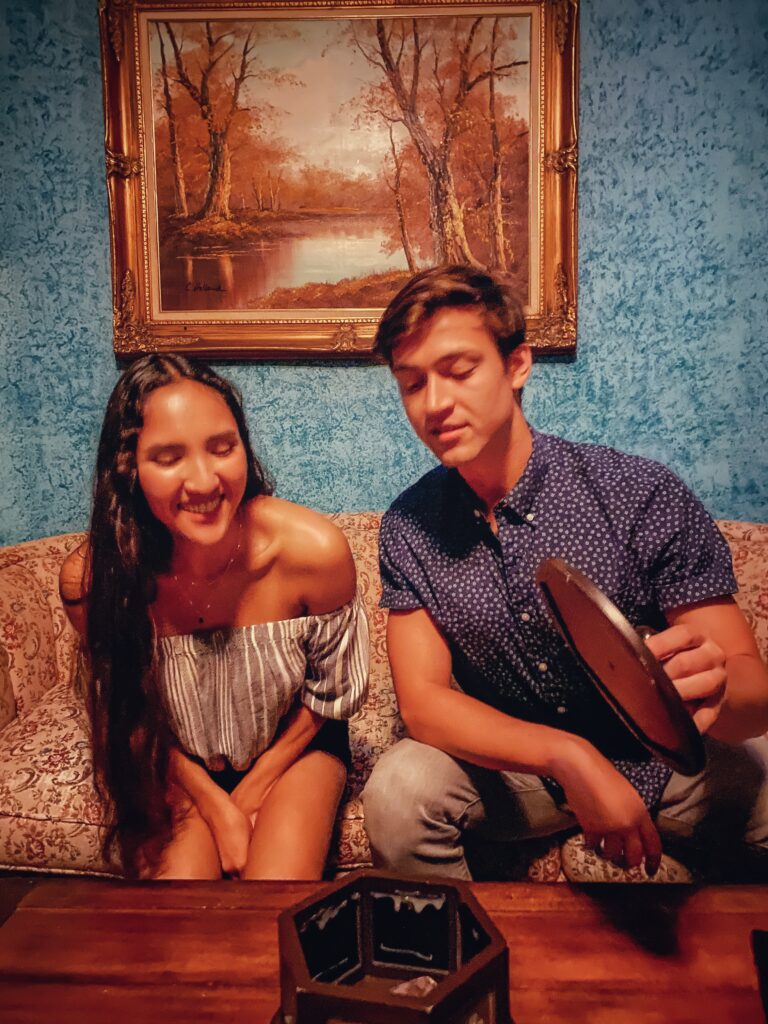one woman and one man playing study in yellow escape room